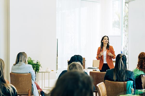 Woman doing a presentation infront of other women