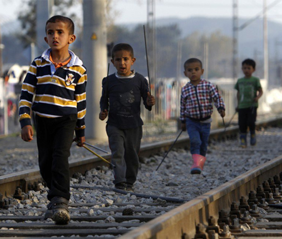 kids walking on train tracks