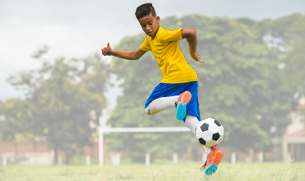 little boy playing soccer